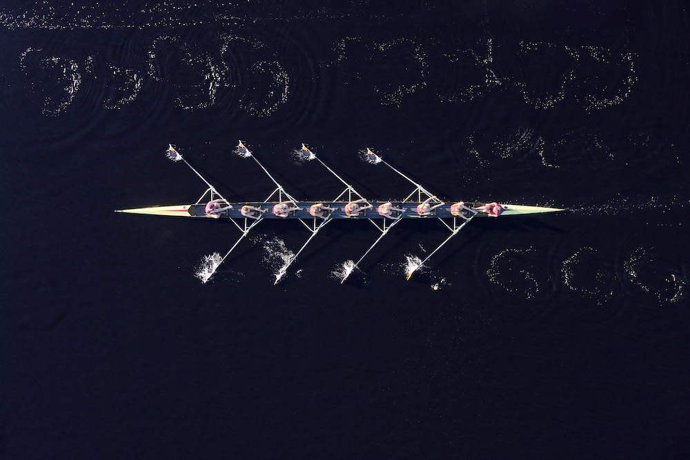 elevated-view-of-female-s-rowing-eight-in-water
